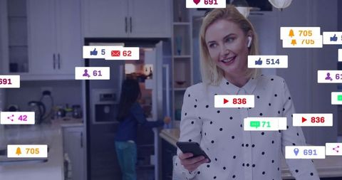 Woman streaming live with smartphone in modern kitchen