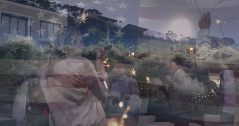 Friends Holding Sparklers During Evening Outdoor Celebration