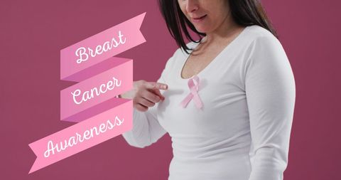 Woman Wearing Pink Ribbon for Breast Cancer Awareness on Pink Background