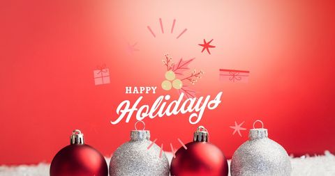 Joyful Holiday Greeting with Christmas Baubles on Red Background