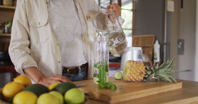 Preparing Fresh Fruit Smoothie in Kitchen, Pouring Water into Blender - Download Free Stock Images Pikwizard.com