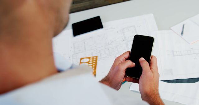 Architect Checking Design Plans on Smartphone at Office Desk - Download Free Stock Images Pikwizard.com