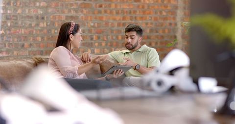 Business colleagues using tablet for collaboration in modern office environment