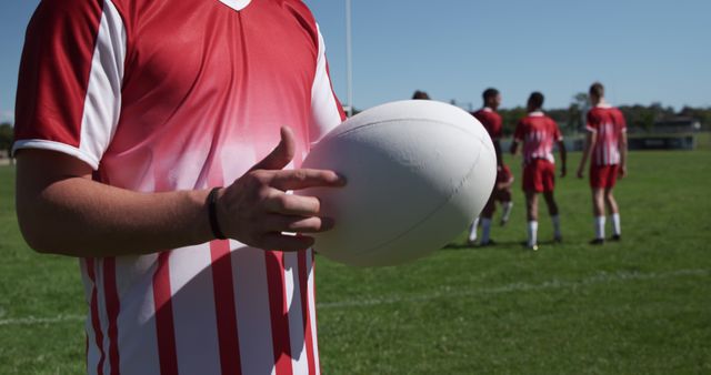 Rugby Player Holding Ball During Team Practice on Field - Download Free Stock Images Pikwizard.com