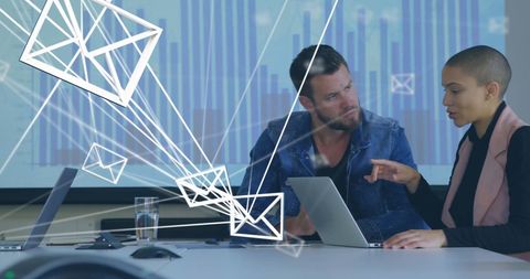 Business team analyzing data with digital email overlays