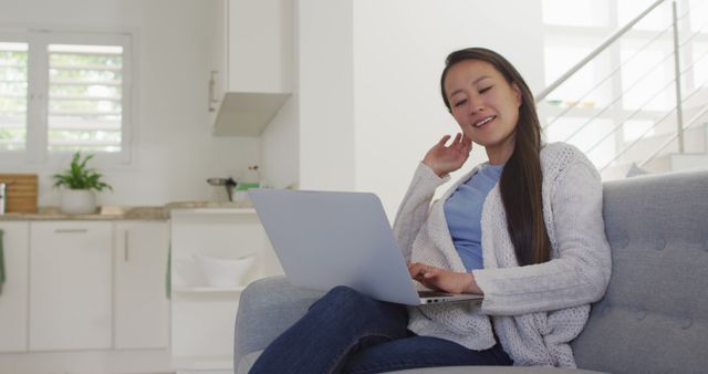 Woman Relaxing on Sofa Using Laptop in Bright Living Room - Download Free Stock Images Pikwizard.com