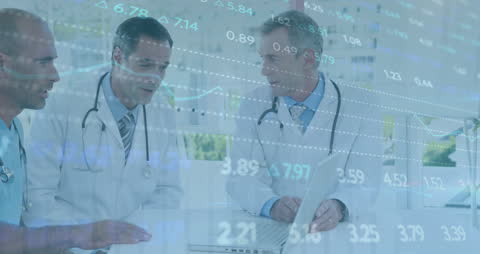Healthcare professionals in discussion with financial data overlay representing the intersection of medicine and technology. Useful for illustrating themes in medical analytics, healthcare finance, and data-driven healthcare innovation.