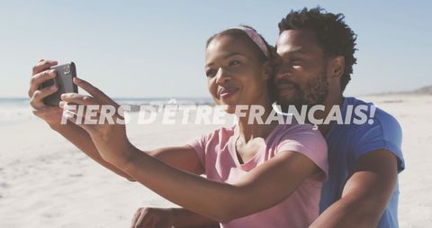 Couple Taking Selfie on Beach Celebrating French Heritage - Download Free Stock Images Pikwizard.com