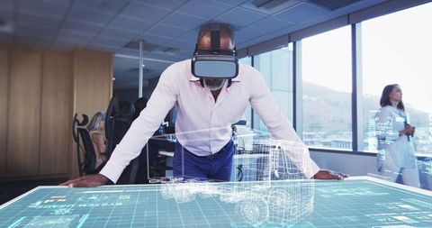 Businessman Engages with Virtual Truck through VR in Modern Office