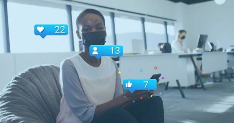 Office worker checking social media on smartphone in lounge area