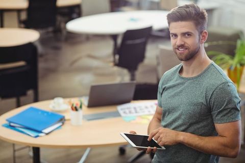 Professional Man Using Tablet in Modern Coworking Office