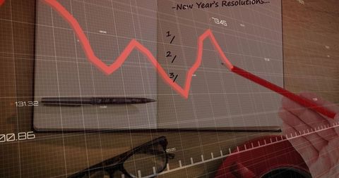Hand sketching red trend line on notebook with data overlay for finance strategy