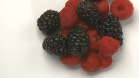 Delicious Mix of Raspberries and Blackberries on White Surface
