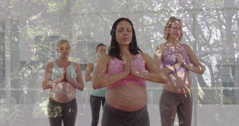 Pregnant Women Practicing Yoga Consulting Mindfulness and Serenity