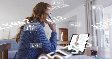 Entrepreneur engaged in video call with digital interface in home office