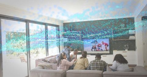 Group watching rugby on TV in modern living room during casual friends gathering