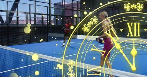 Female athlete playing paddle on indoor blue court with paddle at net and gold clock overlay