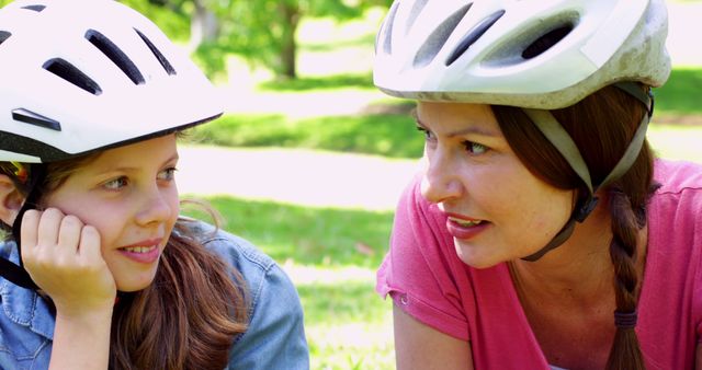 Mother and daughter enjoying a pleasant day in nature, the scene shows safety practices. Ideal for promoting family time, safety awareness, outdoor activities, parent-child relationships, and healthy living.