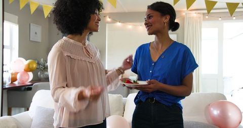 Women Preparing for Lively Birthday Celebration at Home