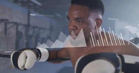 Focused boxer analyzing performance data with hud overlays in boxing ring for sports