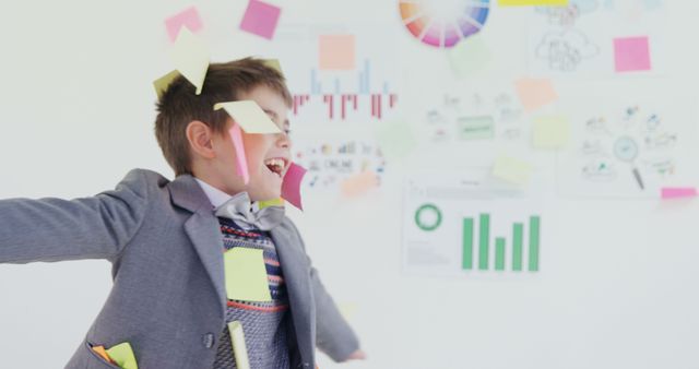 Excited Boy Covered in Sticky Notes Playing in Office Environment - Download Free Stock Images Pikwizard.com