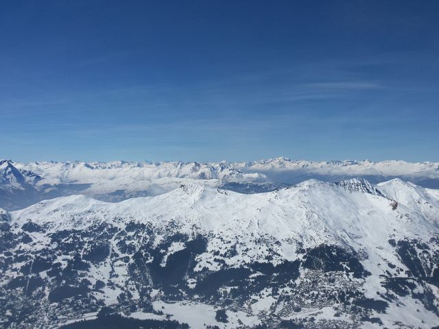 Aerial View of Snow-Covered Mountain Range with Clear Blue Sky - Download Free Stock Photos Pikwizard.com