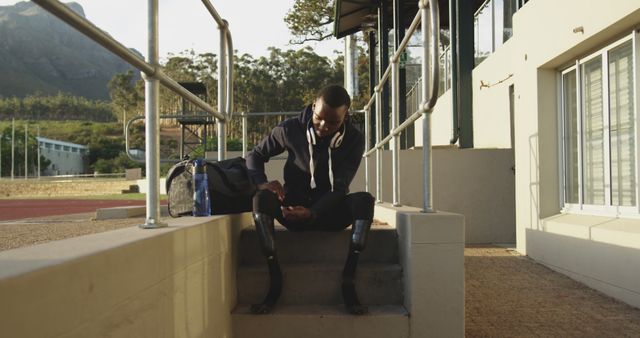 Athlete with prosthetic legs preparing for outdoor training with focus and determination - Download Free Stock Images Pikwizard.com