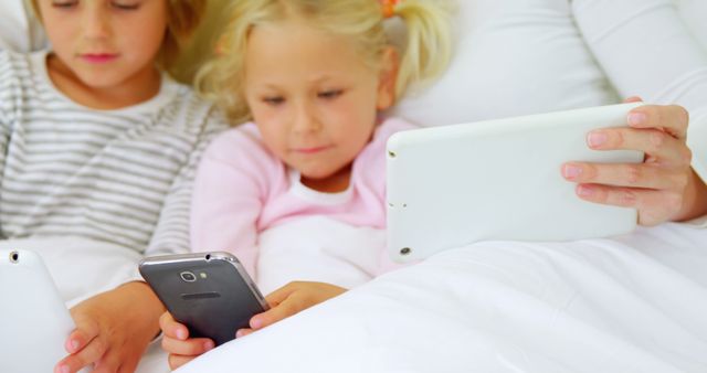 Children and Parent Using Electronic Devices in Bed - Download Free Stock Images Pikwizard.com