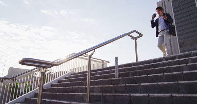 Businessman Walking Upstairs While Checking Smartphone in Sunny Morning - Download Free Stock Images Pikwizard.com