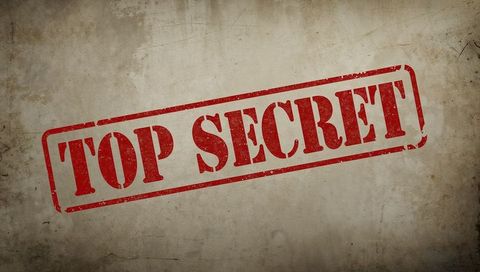 Diagonal red top secret stamp on weathered parchment background for confidential concept