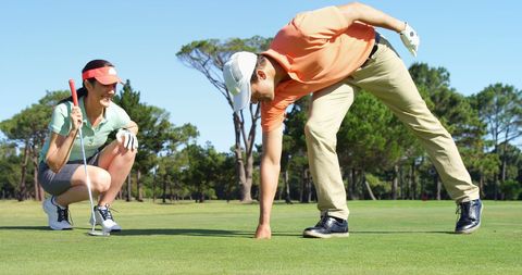 Couple enjoying leisurely golf session on golf course