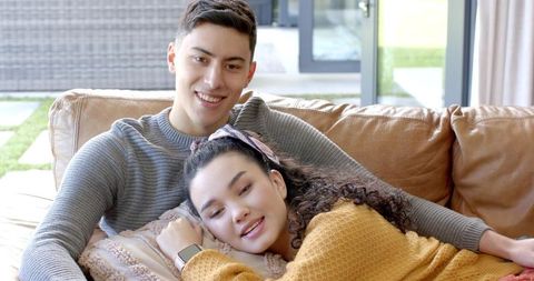 Loving Couple Relaxing on Couch in Cozy Living Room