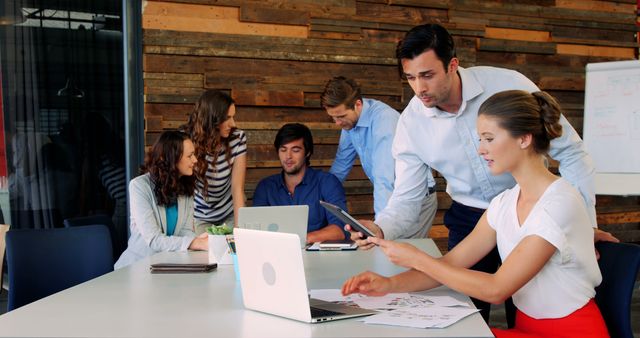 Team Collaborating in Modern Office With Wooden Wall - Download Free Stock Images Pikwizard.com