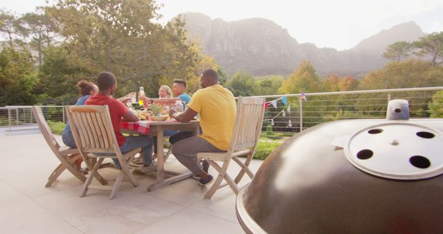 Friends Enjoying Outdoor BBQ While Seated on Patio - Download Free Stock Images Pikwizard.com