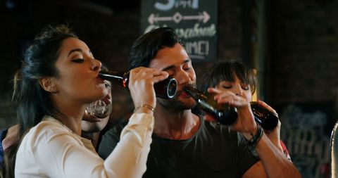 Friends Enjoying Social Night Out in Bustling Pub