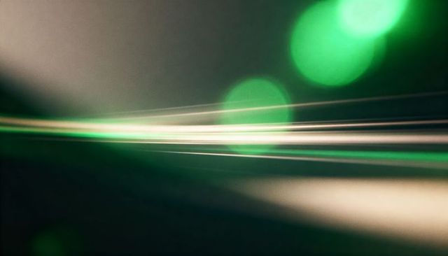 Glowing emerald light trails on thin horizontal wires with soft green bokeh abstract