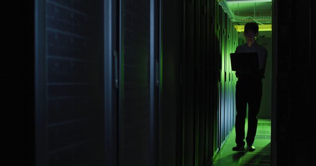 IT Technician Working in Data Center with Green Lighting - Download Free Stock Photos Pikwizard.com