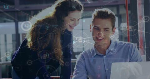 Colleagues Collaborating on Laptop with Digital Network Overlay