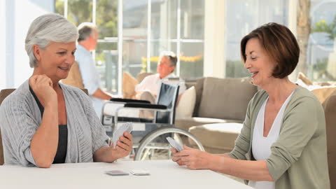 Senior Women Enjoying Card Game in Care Home