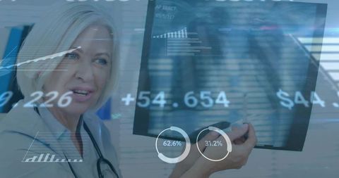 Senior woman doctor presenting tablet with healthcare analytics and imaging dashboard