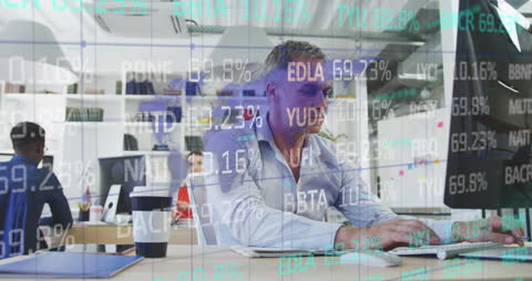 Businessman Analyzing Financial Data on Computer in Office