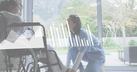 Nurse kneeling assisting wheelchair patient at home with digital health data overlay