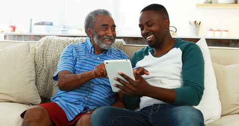 Joyful Multigenerational Tech Interaction on Living Room Couch