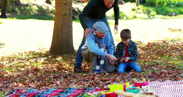 Family Enjoying Picnic in Autumn Park with Grandfather and Grandson - Download Free Stock Images Pikwizard.com