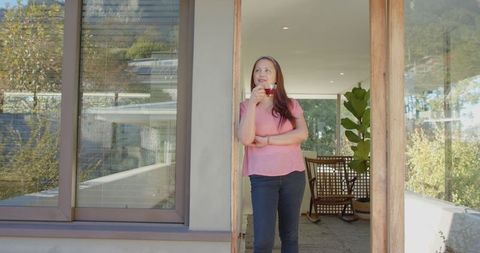 Mature Asian Woman Relaxing at Home with Coffee