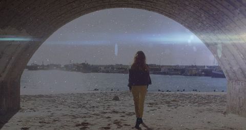 Woman Stands Under Archway Gazing at Tranquil Harbor