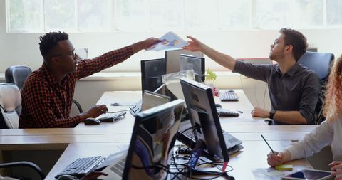 Diverse Colleagues Sharing Documents in Collaborative Office Workspace - Download Free Stock Images Pikwizard.com