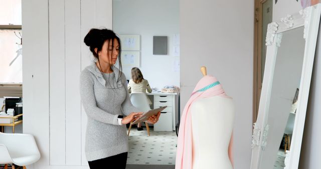 Fashion Designer Working in Studio with Mannequin and Tablet - Download Free Stock Images Pikwizard.com