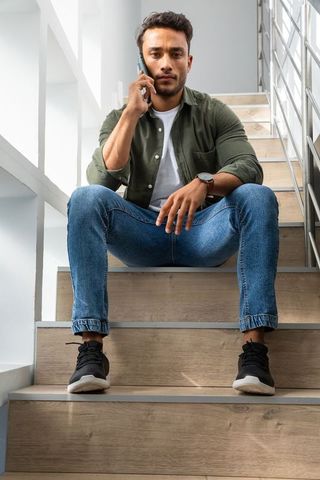 Casual Conversation in Modern Stairwell with Asian Man on Phone