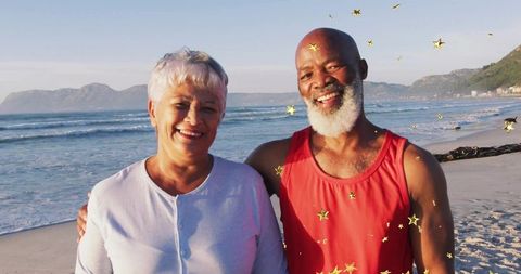 Joyful Older Couple Celebrating on Serene Beach